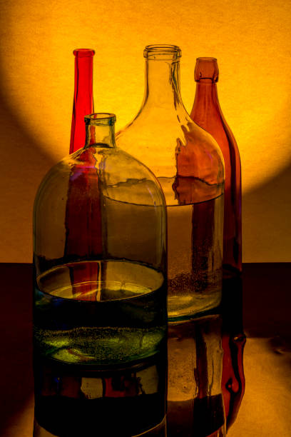 istock Still life with colored glassware on a yellow background 1225907795