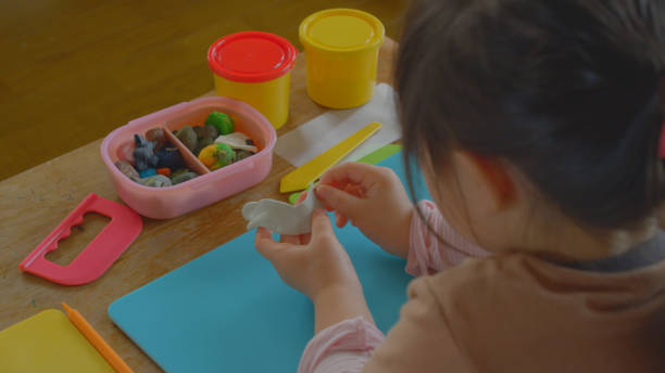 istock Young girl enjoy playing with clay at home. 1225908932