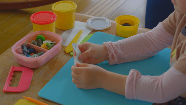 istock Young girl enjoy playing with clay at home. 1225908936