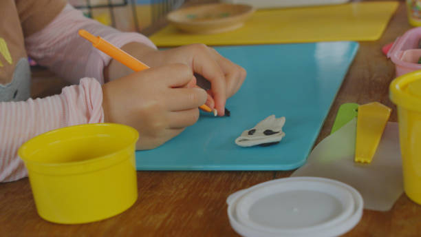 istock Young girl enjoy playing with clay at home. 1225908955