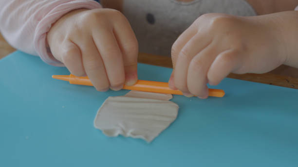 istock Young girl enjoy playing with clay at home. 1225909131