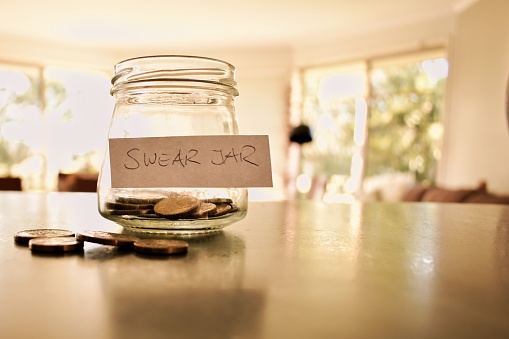 Glass jar on kitchen counter - money concept