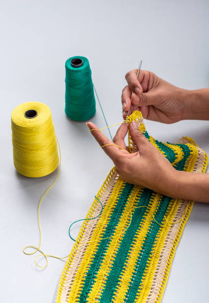 istock Woman crocheting pattern with crochet hook close-up. 1225909736