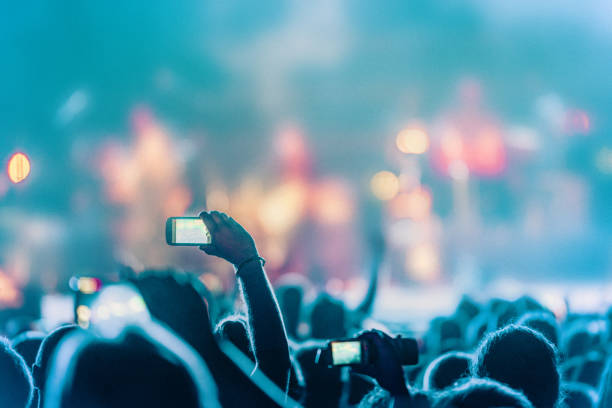 istock cheering crowd at rock concert 1225915153