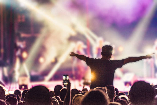 istock cheering crowd at rock concert 1225915719