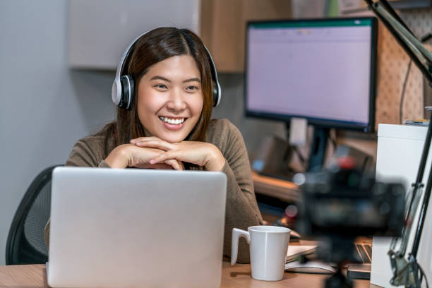 istock Asian woman using technology laptop and working from home in bedroom 1225916077