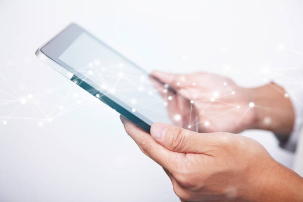 istock Close-up of Man's Hands Holding and Watching on Digital Tablet with Blockchain Network Polygon Graphics 1225916149