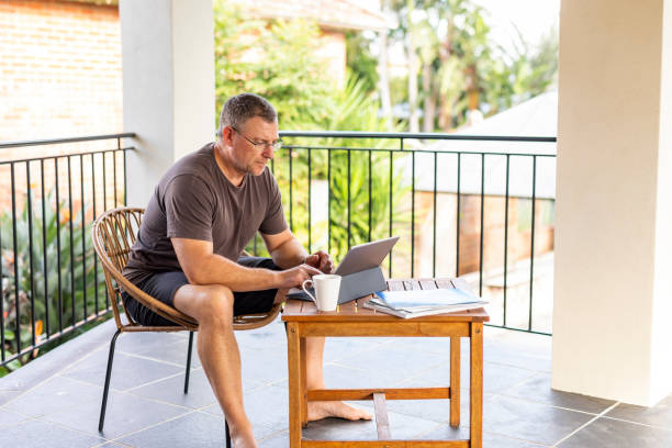 istock Mature Man Working From Home on a Balcony Patio 1225919074