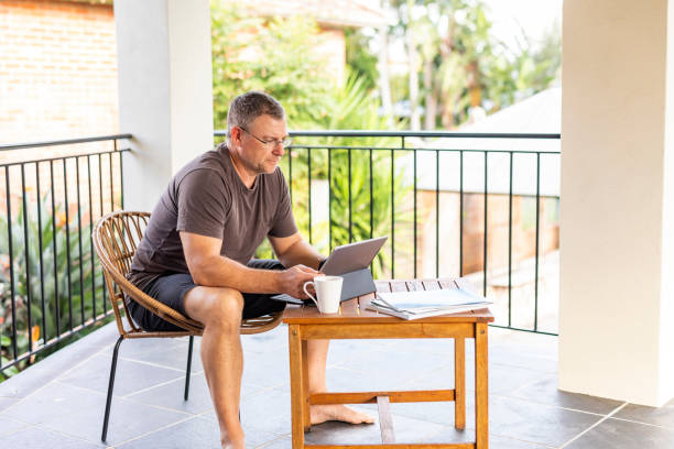 istock Mature Man Working From Home on a Balcony Patio 1225919100
