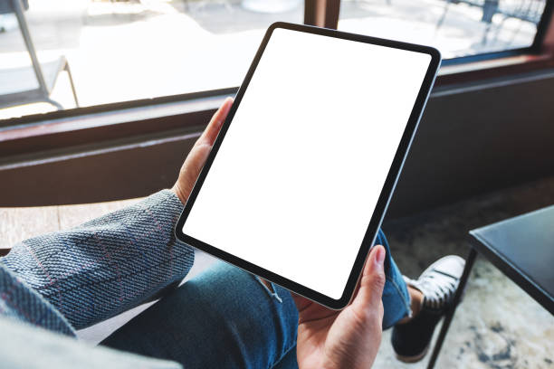 istock a woman holding black tablet pc with blank white desktop screen 1225920356