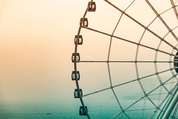 Mysterios inactive ferris wheel by heavy fog evening