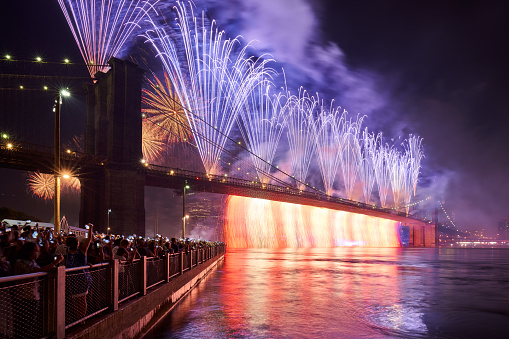New York City, NY, USA - July 04, 2019: 4th of July Independence Day Fireworks (Macys) over the Brooklyn Bridge. Lower Manhattan