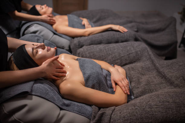 istock two women get face and neck massage in spa salon 1225922846