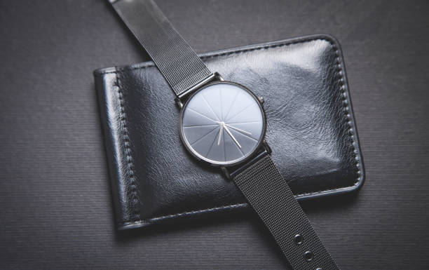 istock Black wristwatch and wallet on the black background. 1225924823