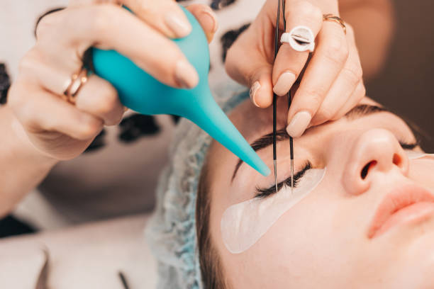 istock eyelash extensions - blowing and drying glued eyelashes 1225926328