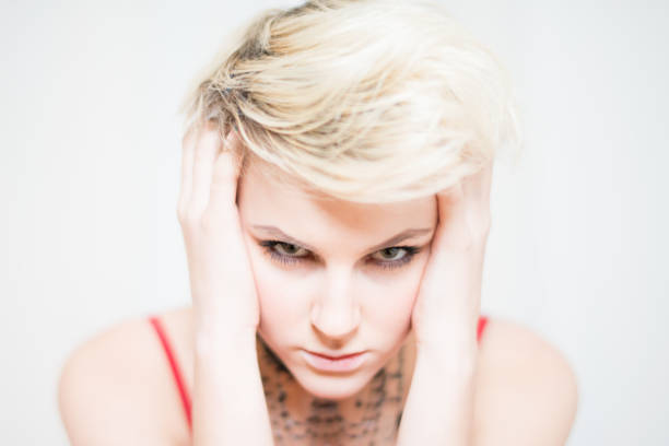 istock Angry Glimpse Blonde Young Woman Head in Hands 1225926712