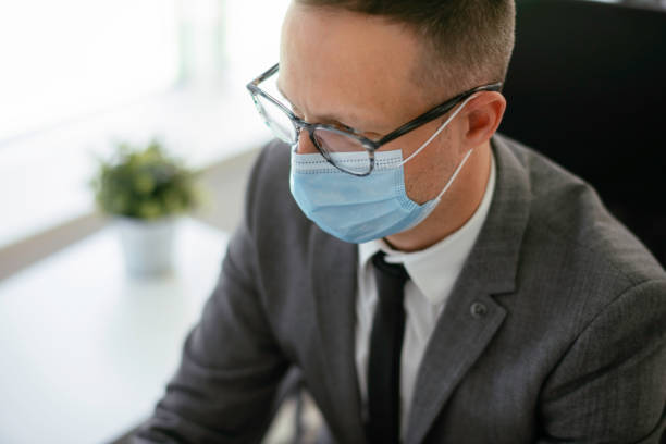 istock Handsome businessman with medical mask 1225927542