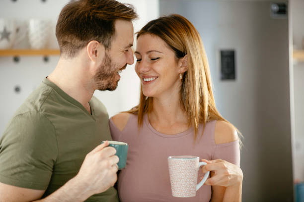 istock Young couple drinking coffe together at home 1225927721