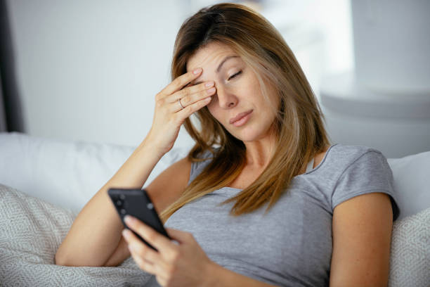 istock Young beautiful woman using phone in bed. 1225927750