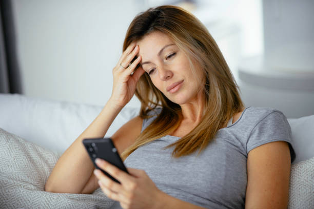 istock Young beautiful woman using phone in bed. 1225927759