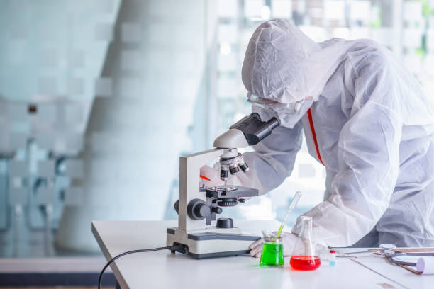 istock coronavirus covid 19, medical looking through a microscope for Corona Virus in laboratory for Prevention of pandemic, biological protective Epidemic virus outbreak concept. 1225930373
