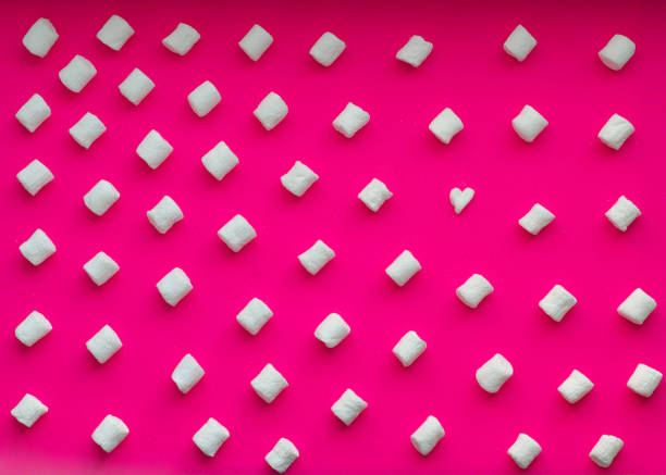 istock Marshmallows on pink background. Flat lay. Top view. Background texture of mini marshmallows 1225930375
