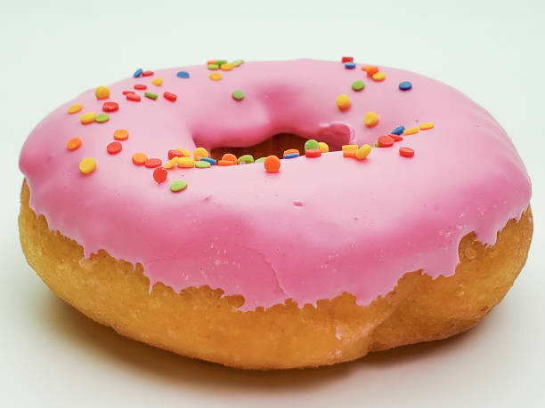 istock Delicious pink donut on a white background close-up 1225930440