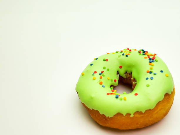 istock Glazed green donut on white background 1225930459