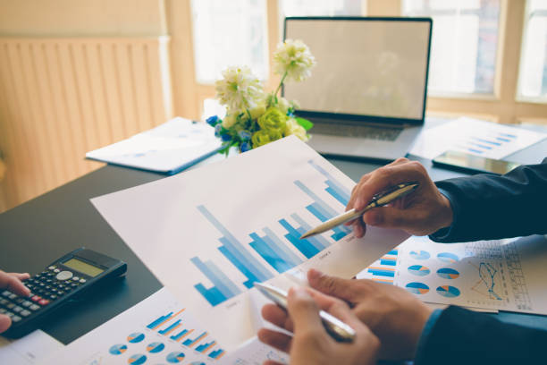 istock Businessman analysis on Graph data paper  using calculator, finance concept in office. 1225930512