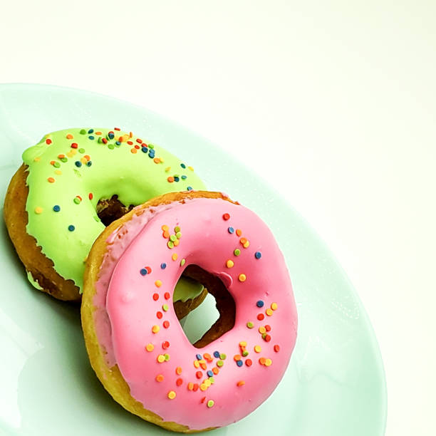 istock donuts pink and green on a blue plate closeup 1225930531