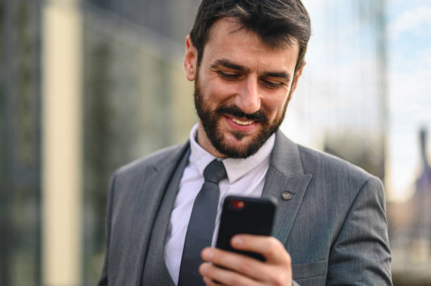 istock Businessman using smart phone and walking down the street 1225931764