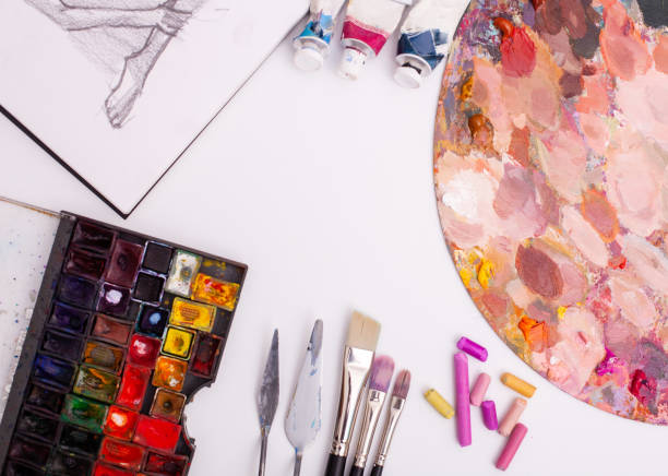 istock oil paints, palette knife and paint brushes on a palette 1225931992