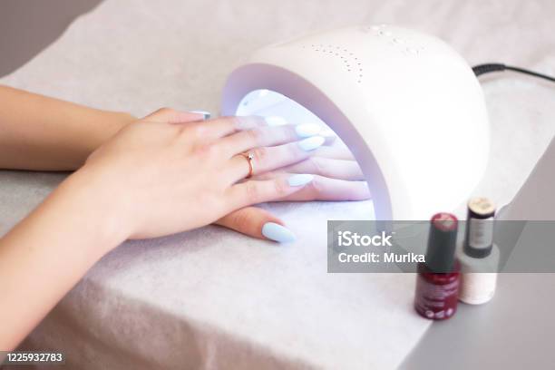 Woman Using Uv Light Dryer Manicure Spa Salon Concept Beauty And Fashion Stock Photo - Download Image Now