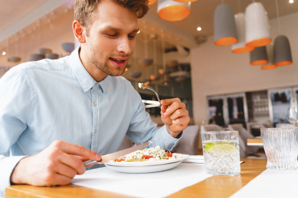 istock Good-looking young man having lunch in restaurant 1225932931