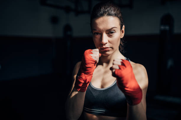 istock Female boxer standing alone in gym 1225935030