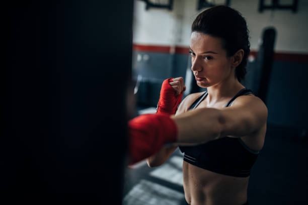 istock Female boxer training alone in gym 1225935816