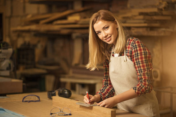 istock smiling carpenter woman at work 1225935983