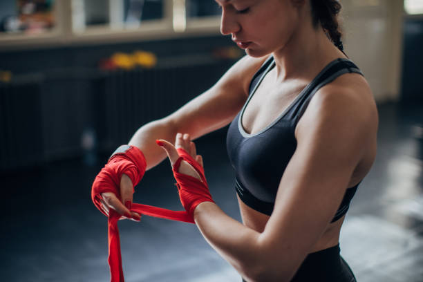 istock Female boxer wrapping bandages on hands 1225936013