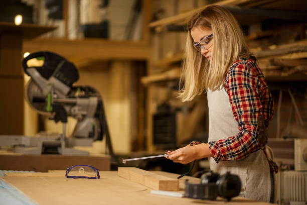 istock skillful woodworker woman with tape-line in hands 1225936027