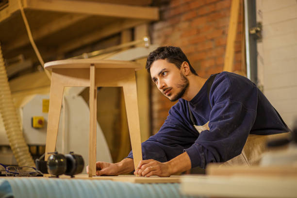 istock cerpenter checking wooden chair after grinding 1225936413