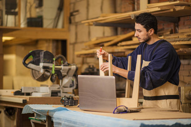 istock hardworking carpenter making wooden chair on an order 1225938693