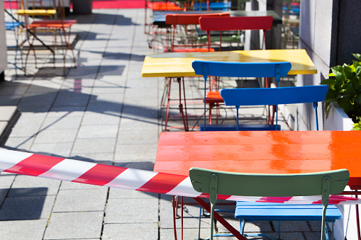 Barrier tape around the empty terraces in Rotterdam during lockdown because of the coronavirus pandemic