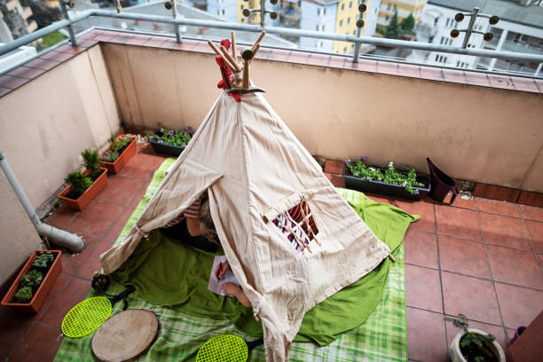 Kids playing in teepee tent on balcony