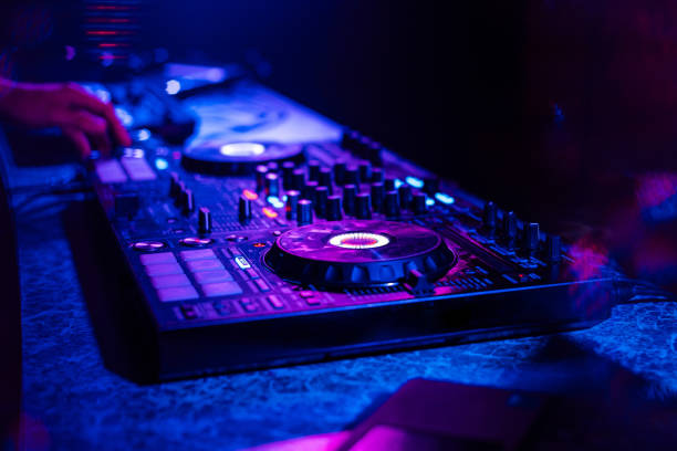 istock DJ mixer controller at a party in a nightclub 1225939315