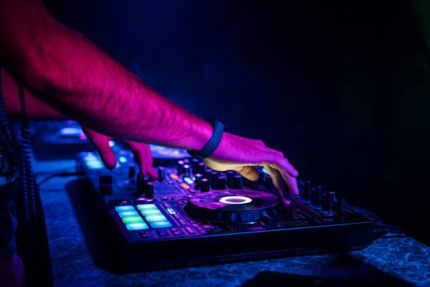 istock hands of a DJ mixing music on a professional controller in a booth 1225939329