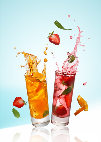 Fresh natural fruit  cocktails with straw on white background.
