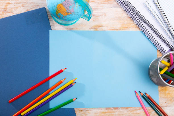 istock Multicolored pencils and notebooks on the table with place for text. School supplies 1225941367