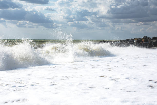istock Big waves roll up on the beach 1225943624