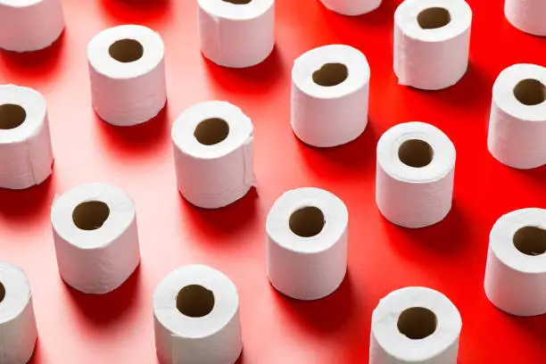 Toilet paper roll pattern on a red background