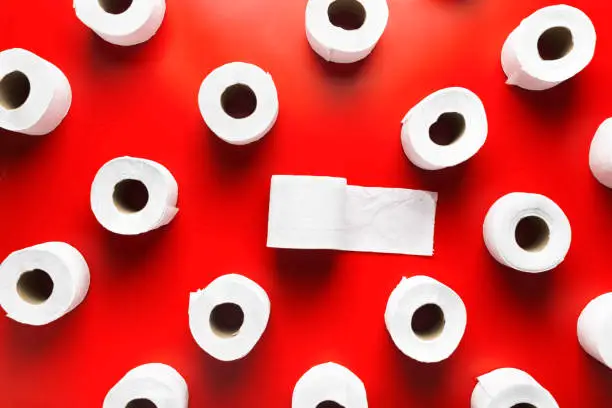 Toilet paper roll pattern on a red background. Top view